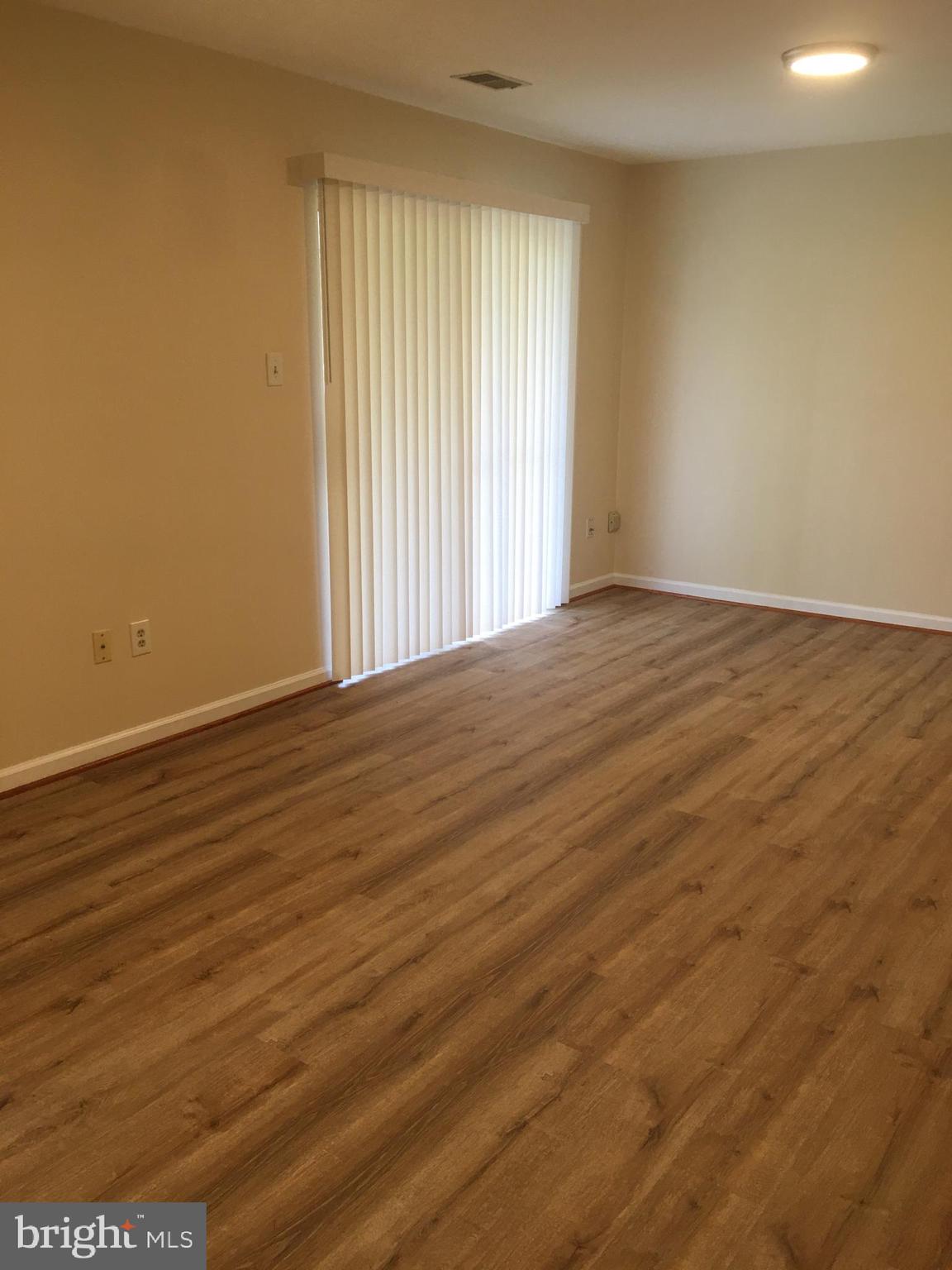 6159 Good Hunters Ride Columbia, MD 21045 - Photo 25 of 28 a view of an empty room with wooden floor and a window