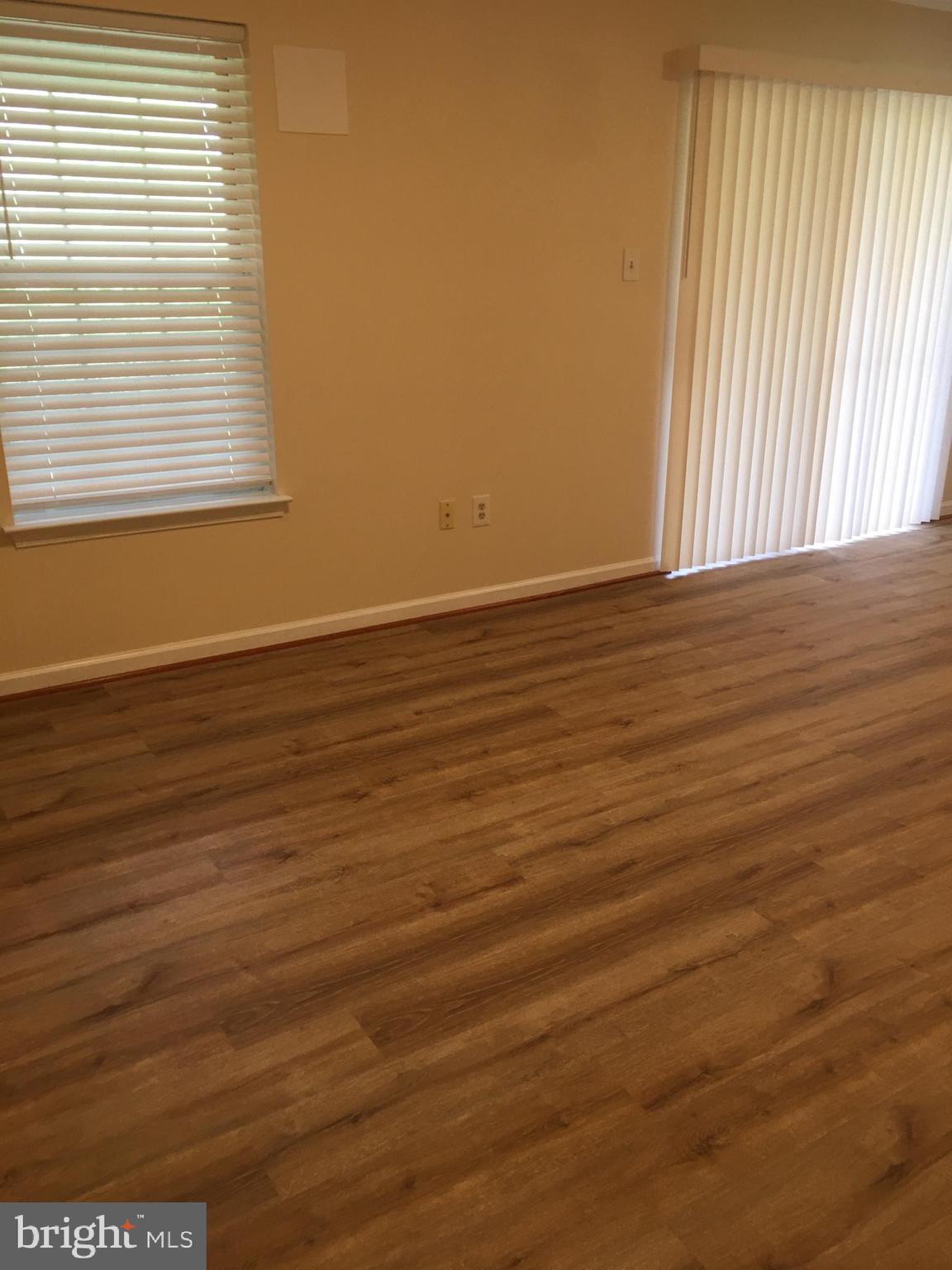 6159 Good Hunters Ride Columbia, MD 21045 - Photo 26 of 28 an empty room with wooden floor and windows
