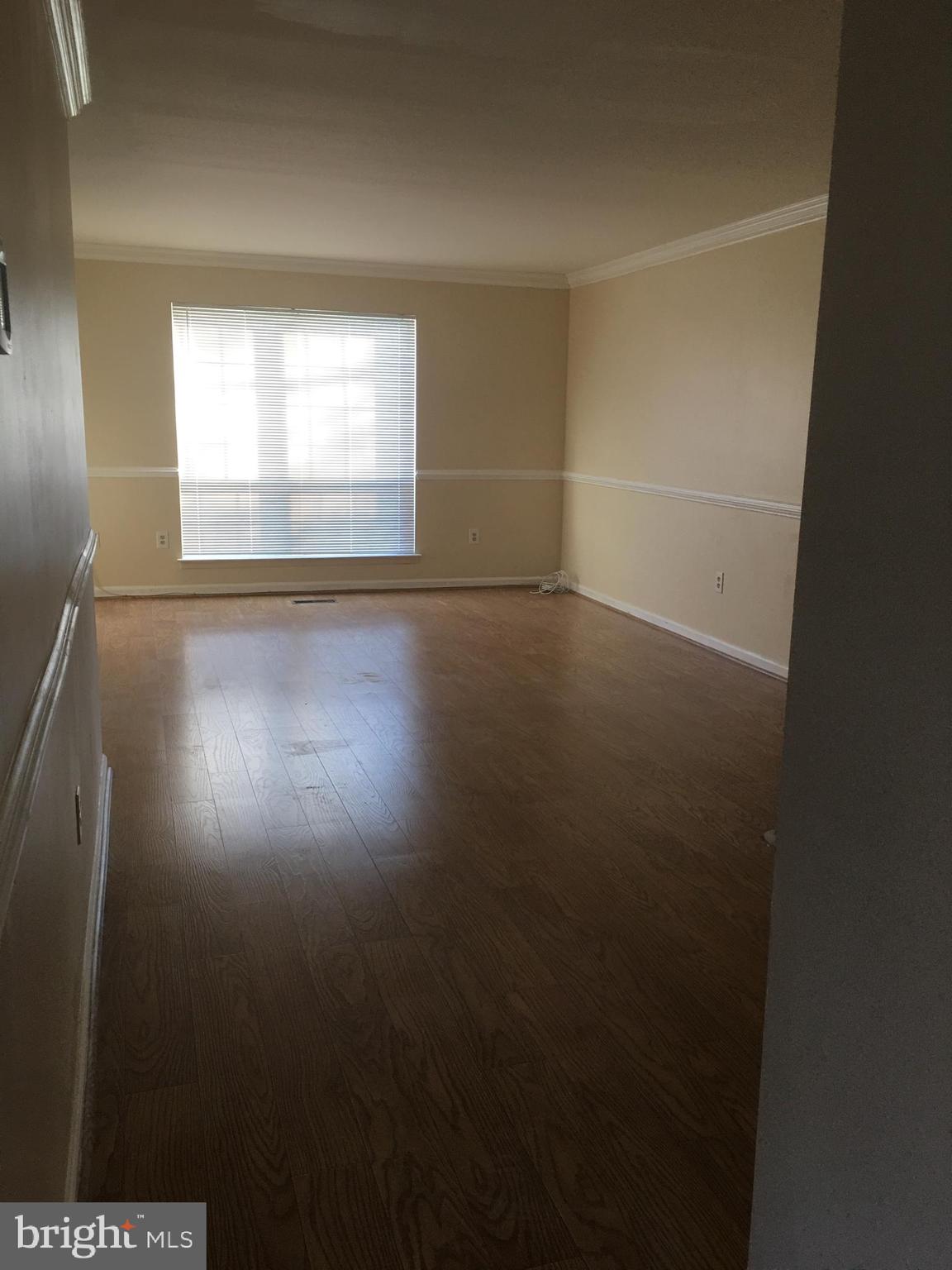6159 Good Hunters Ride Columbia, MD 21045 - Photo 3 of 28 an empty room with wooden floor and windows