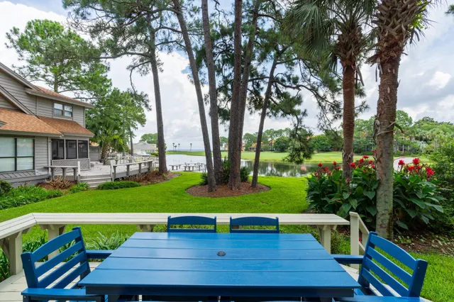 a view of a wooden chairs and table on the wooden deck