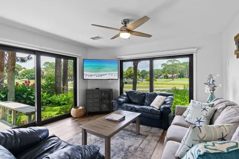a living room with furniture and a floor to ceiling window