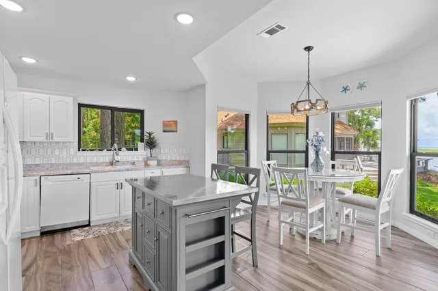 a kitchen with center island and stainless steel appliances