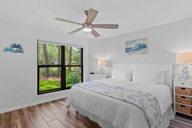 a bedroom with a bed and a large window