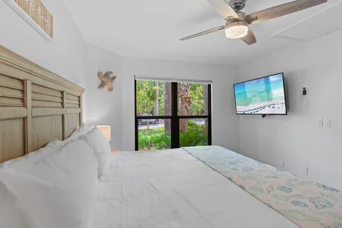 a large bed sitting in a bedroom next to a window