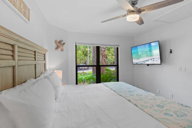 a large bed sitting in a bedroom next to a window