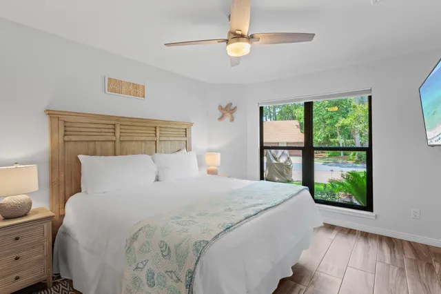 a bedroom with a balcony a bed and a window