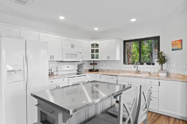 a kitchen with a sink window and cabinets