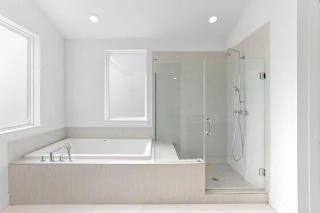 a bathroom with a bathtub and shower