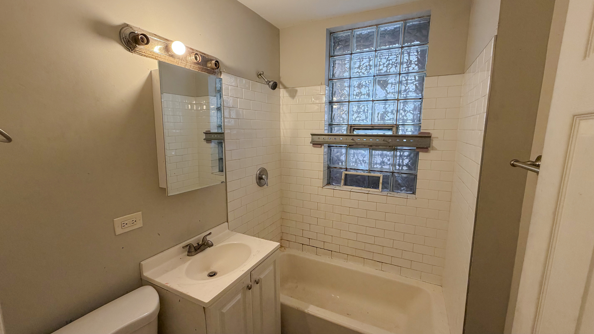 435 East 88th Place Chicago, IL 60619 - Photo 12 of 21 a bathroom with a sink and a shower