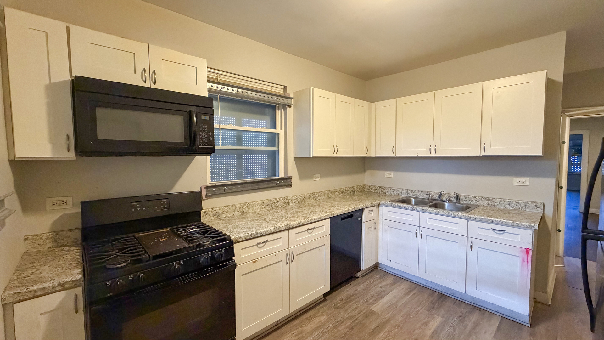435 East 88th Place Chicago, IL 60619 - Photo 13 of 21 a kitchen with stainless steel appliances granite countertop a stove and a microwave