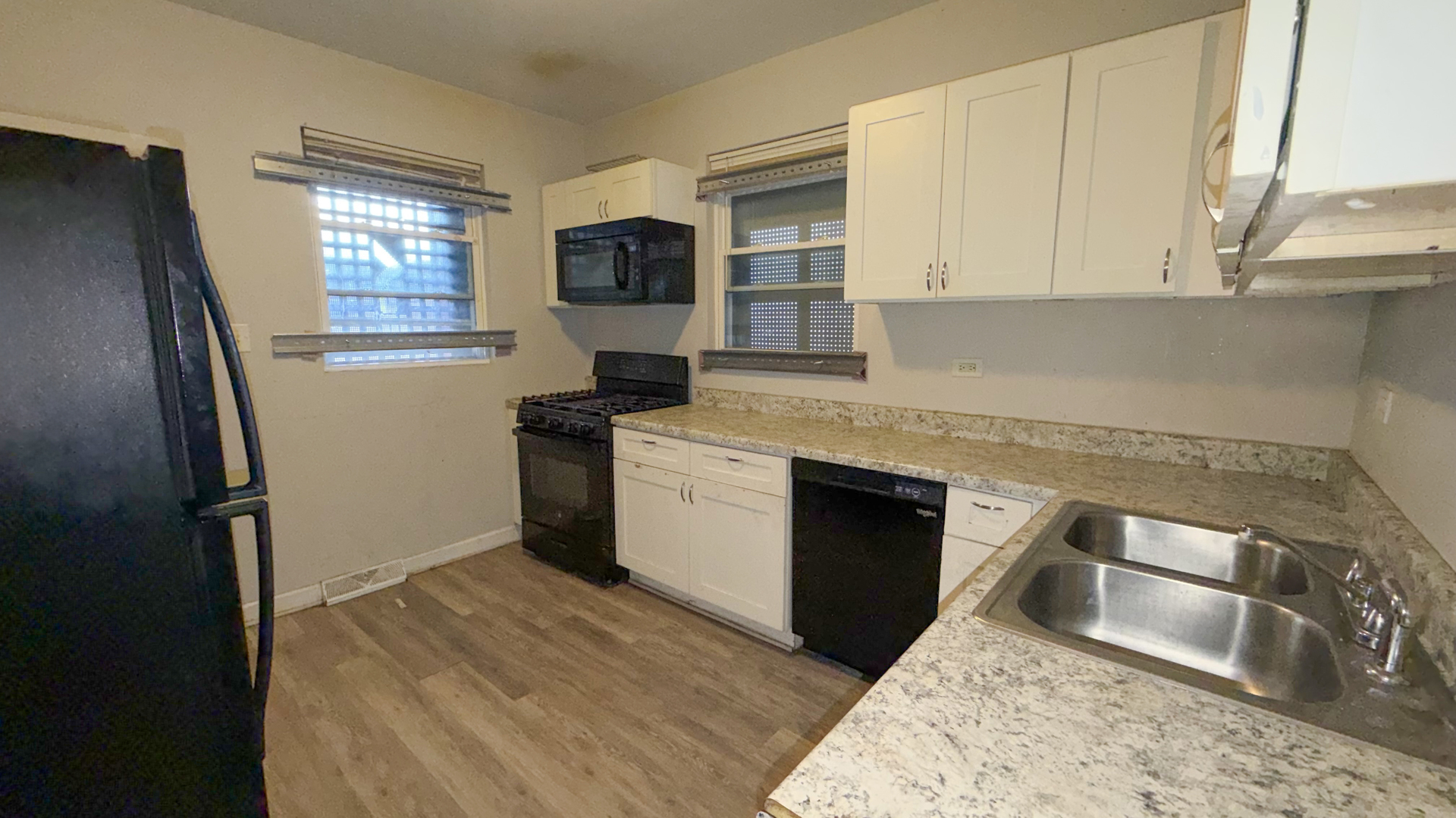 435 East 88th Place Chicago, IL 60619 - Photo 14 of 21 a kitchen with a sink stove and refrigerator