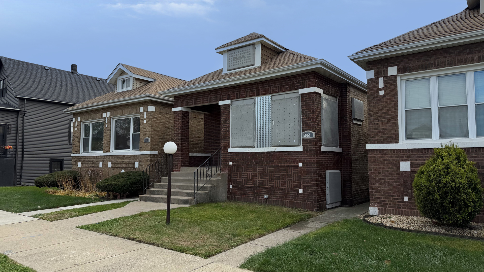 435 East 88th Place Chicago, IL 60619 - Photo 2 of 21 a front view of a house with a garden