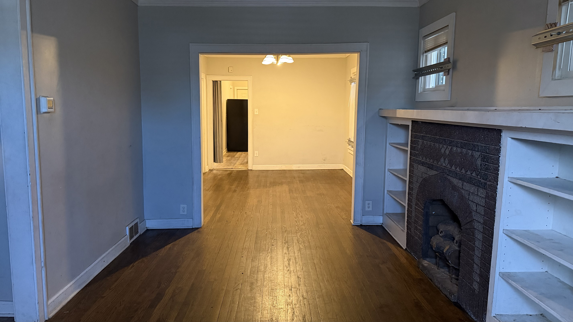 435 East 88th Place Chicago, IL 60619 - Photo 6 of 21 a view of hallway with wooden floor and a fireplace