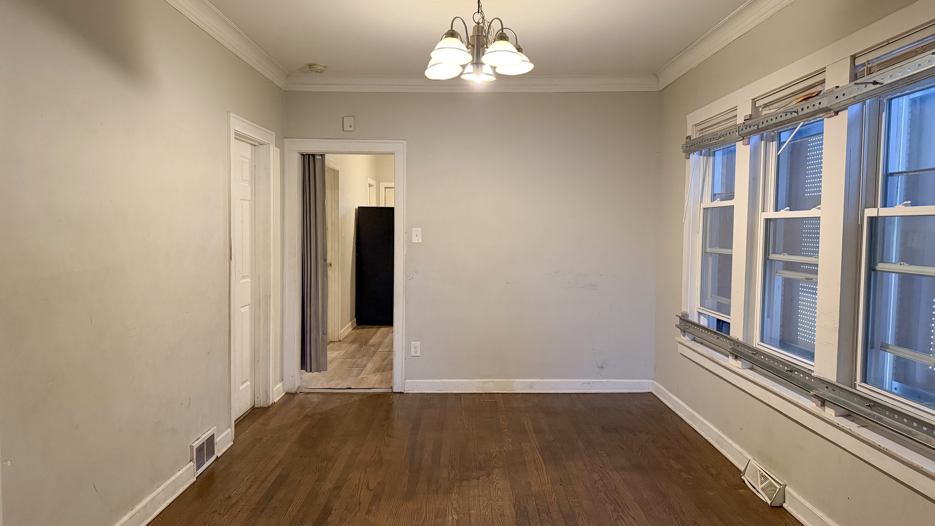 435 East 88th Place Chicago, IL 60619 - Photo 7 of 21 a view of an empty room with wooden floor and a window