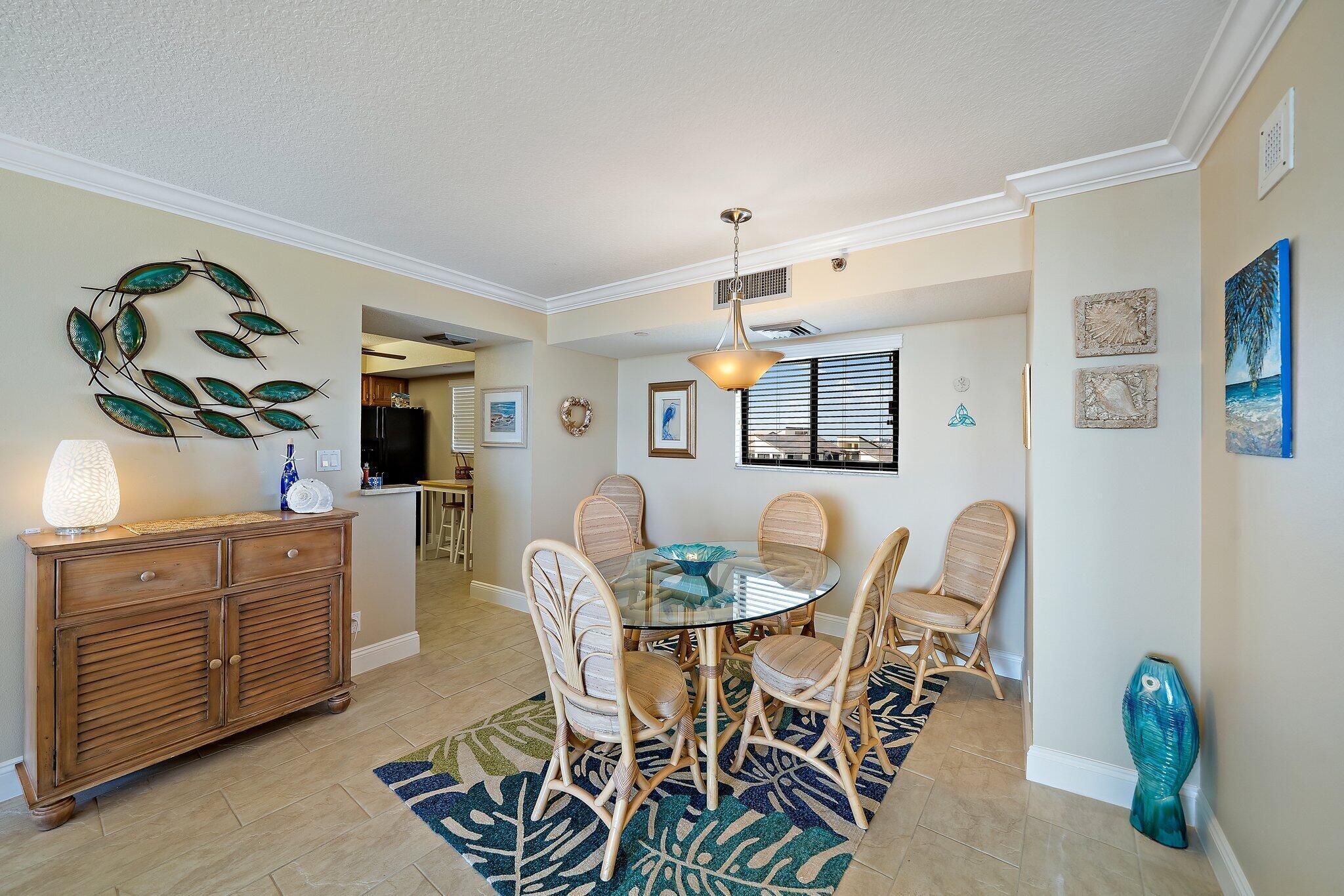 100 Ocean Trail Way, Unit 609 Jupiter, FL 33477 - Photo 11 of 66 a view of a dining room with furniture and wooden floor