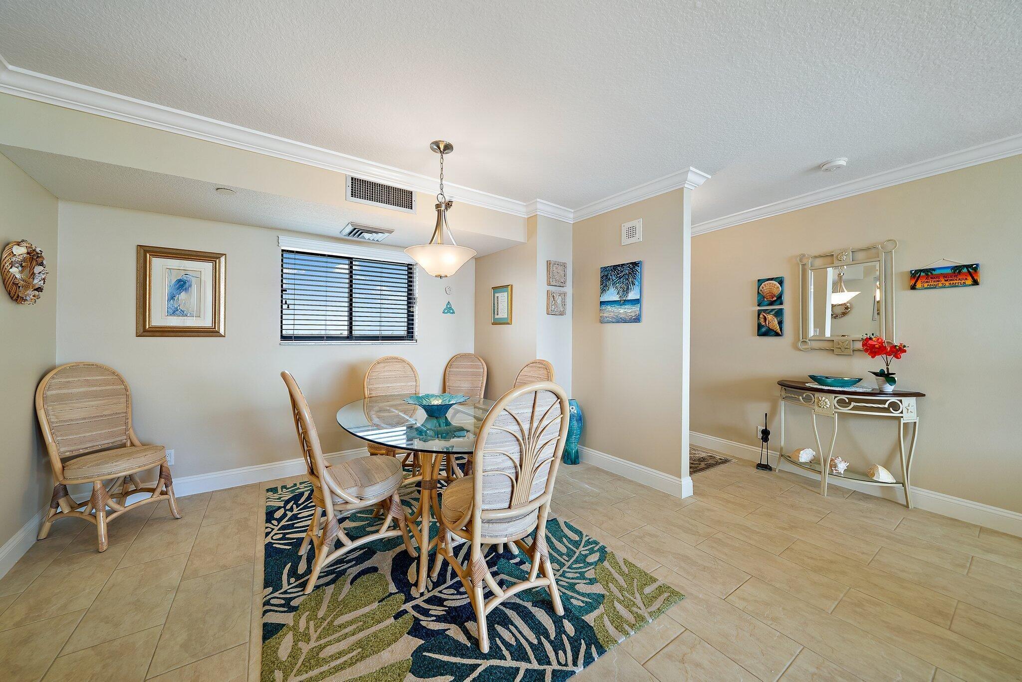 100 Ocean Trail Way, Unit 609 Jupiter, FL 33477 - Photo 12 of 66 a view of a dining room with furniture and a chandelier