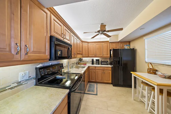 a kitchen with refrigerator cabinets and furniture