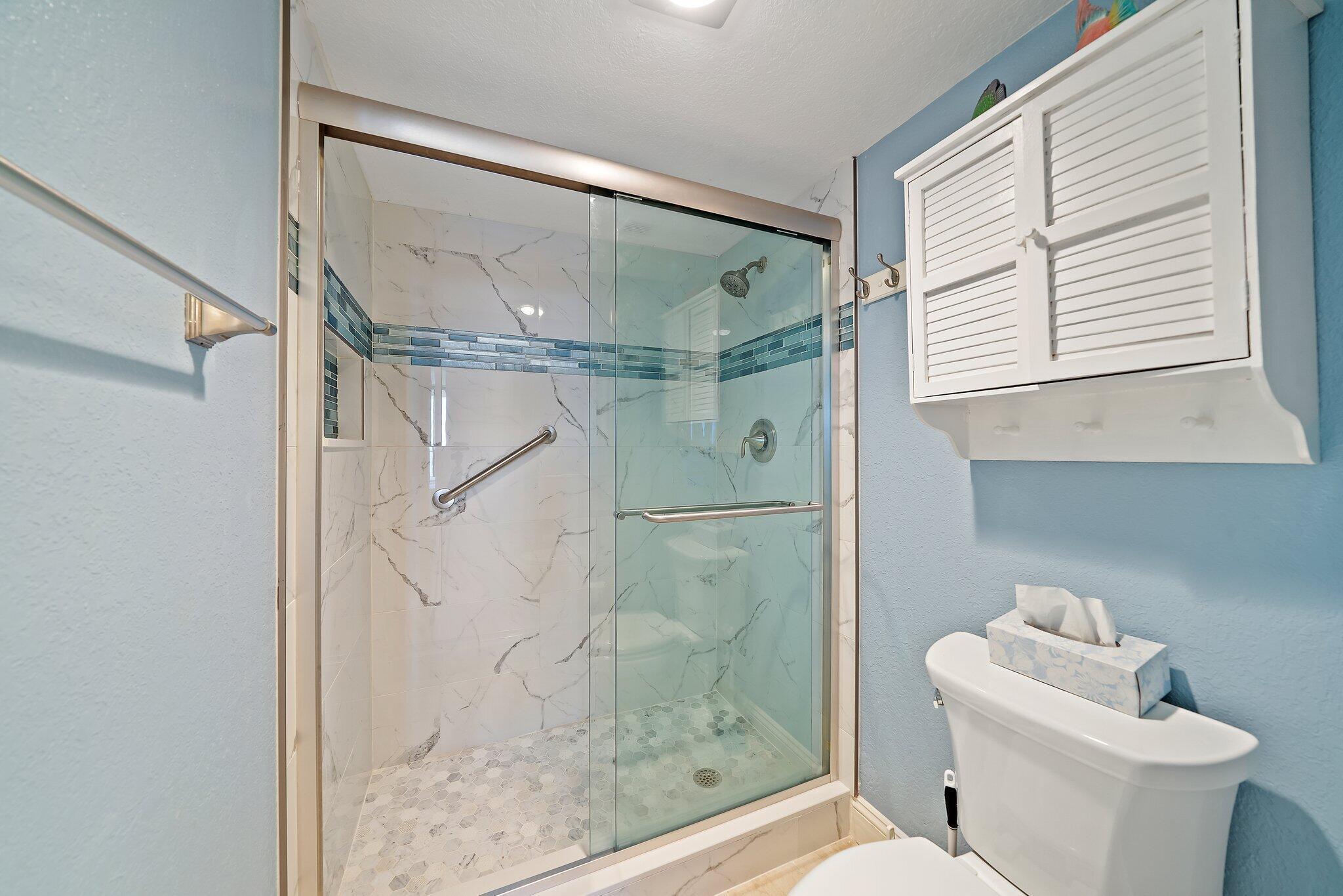100 Ocean Trail Way, Unit 609 Jupiter, FL 33477 - Photo 23 of 66 a bathroom with a shower and toilet