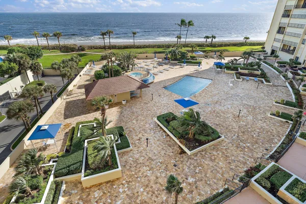 a view of swimming pool with outdoor seating and plants