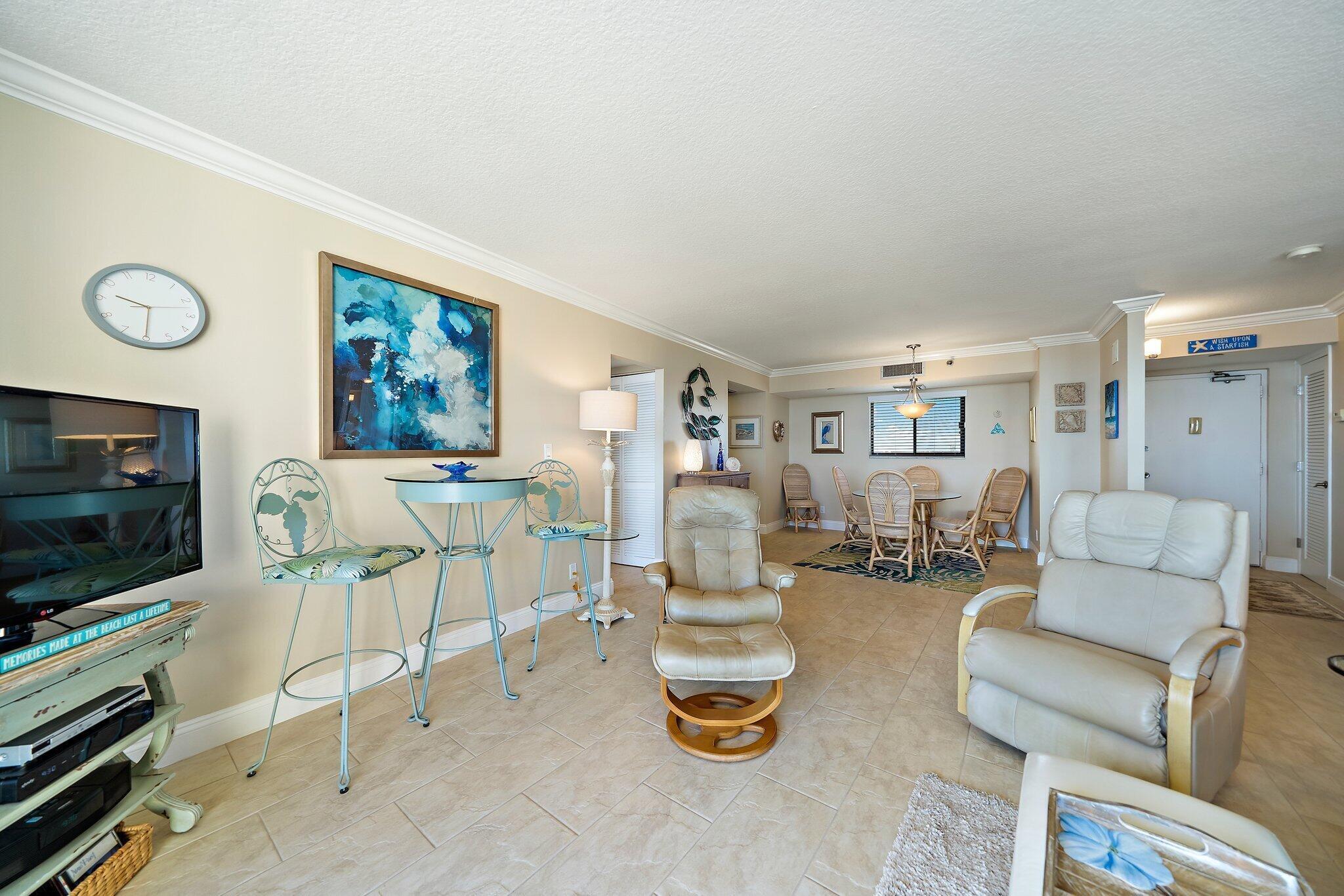 100 Ocean Trail Way, Unit 609 Jupiter, FL 33477 - Photo 9 of 66 a living room with furniture and a flat screen tv
