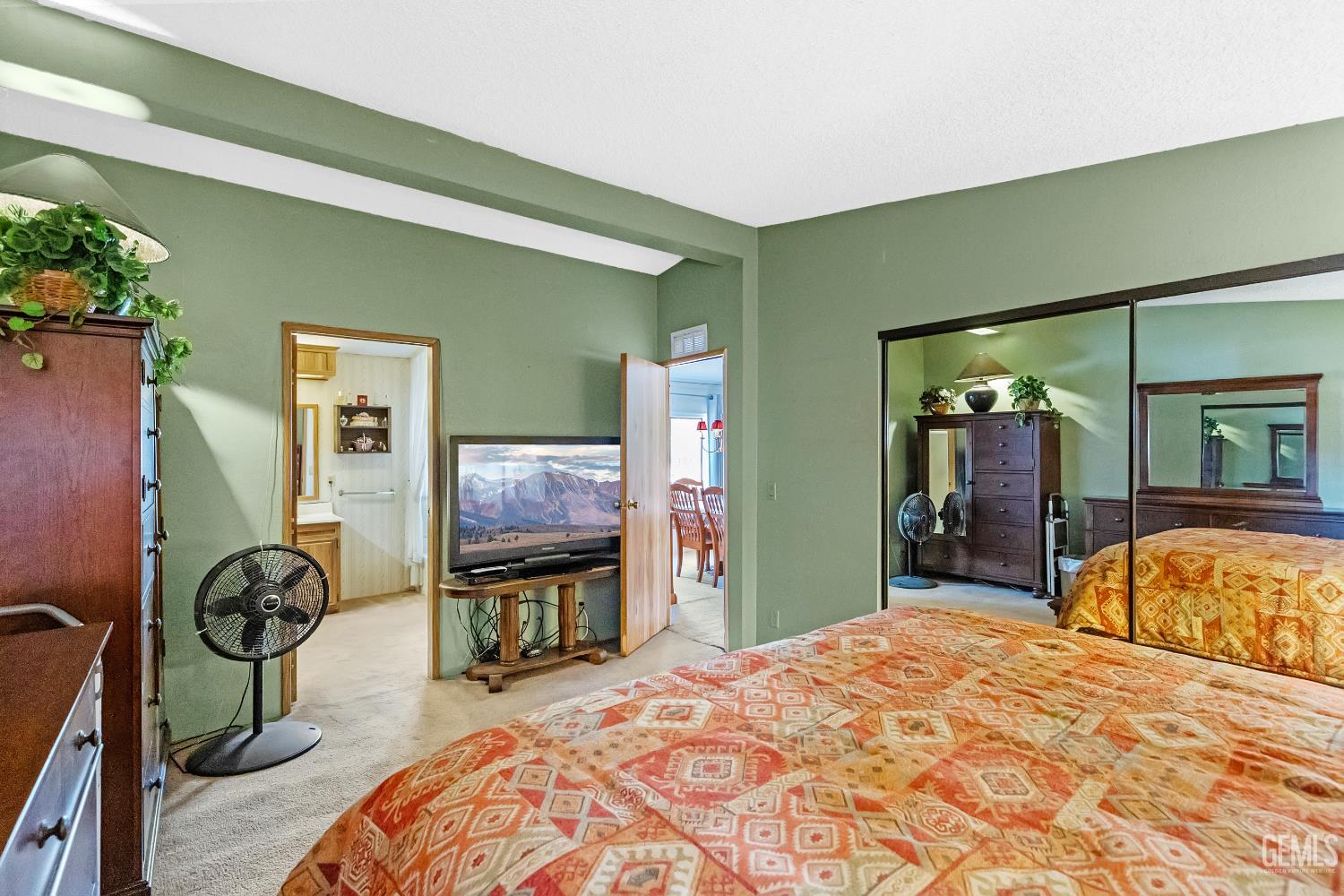 Undisclosed Address Tehachapi, CA 93561 - Photo 14 of 32 a bedroom with a bed dresser and a large mirror