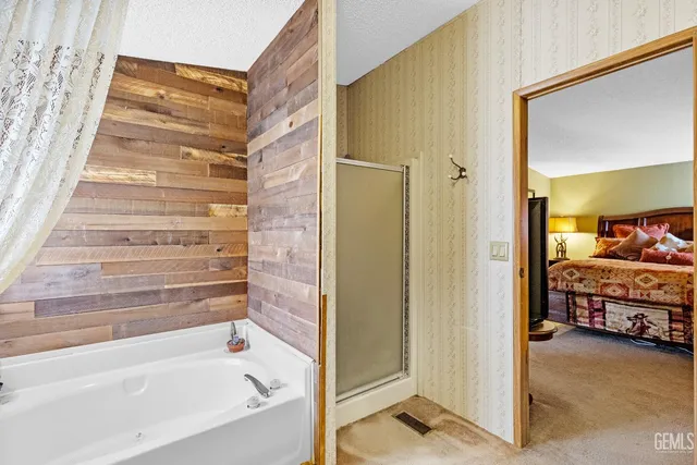 a bathroom with a tub and shower