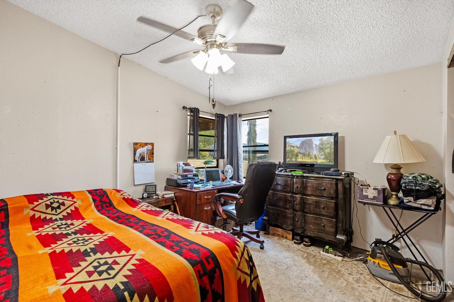 Undisclosed Address Tehachapi, CA 93561 - Photo 16 of 32 a bedroom with furniture a bed and a chandelier