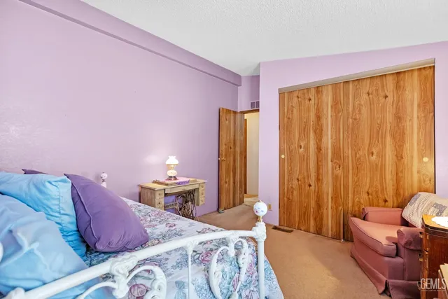 a bed room with a bed and a chair