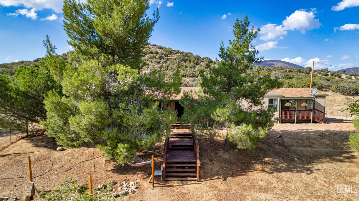 Undisclosed Address Tehachapi, CA 93561 - Photo 25 of 32 a front view of a house with a yard