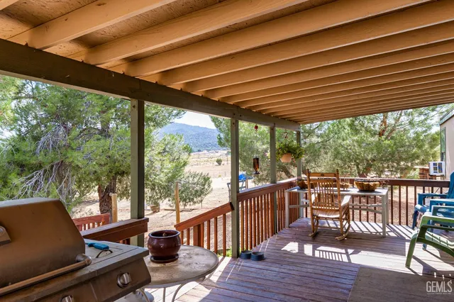 a view of a chair and tables in the balcony