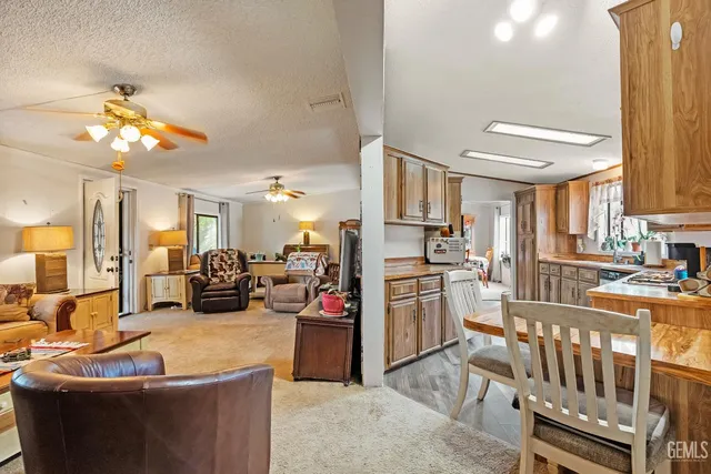 a living room with stainless steel appliances kitchen island granite countertop furniture and a kitchen view