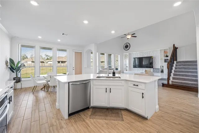 a large kitchen with stainless steel appliances microwave and stove top oven