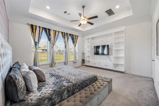 a spacious bedroom with a large bed and a tv