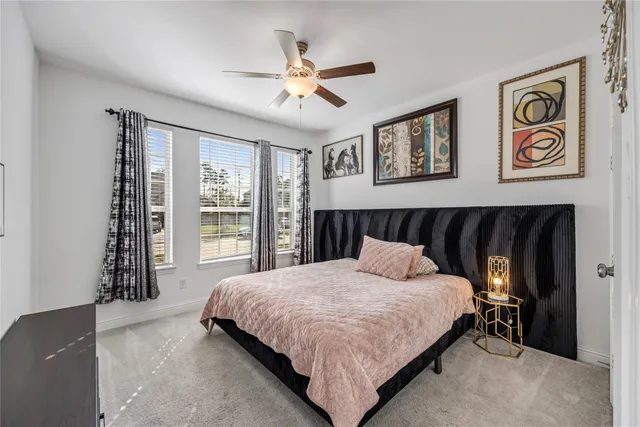 a bedroom with a large bed and a window