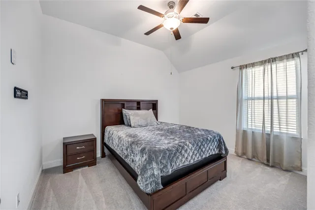 a bedroom with a bed and a tv