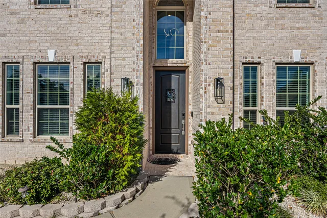 front view of a brick house with a large window