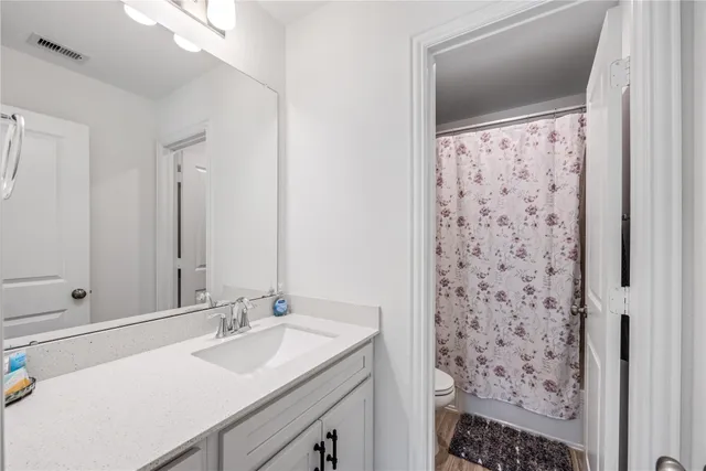 a bathroom with a sink a mirror and a shower