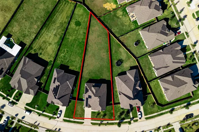 an aerial view of houses with yard