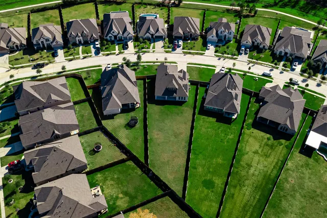 an aerial view of houses with outdoor space