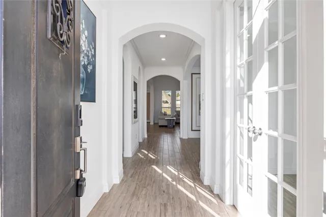 a view of a hallway view with wooden floor and staircase