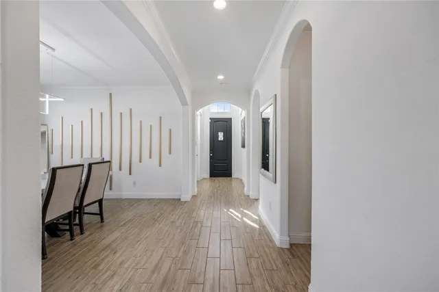 a view of a hallway with wooden floor and staircase