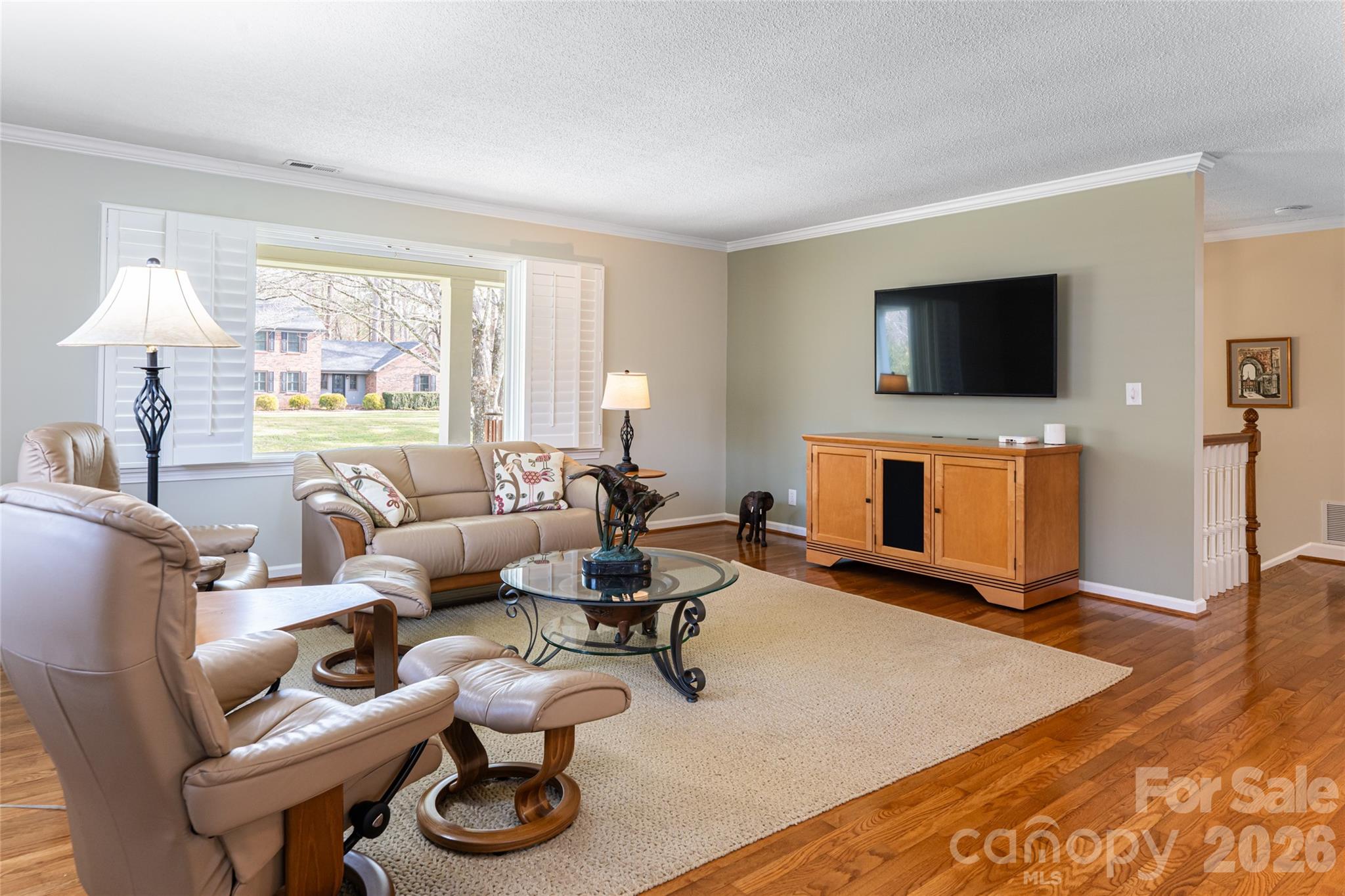 774 Crooked Creek Road Hendersonville, NC 28739 - Photo 12 of 46 a living room with furniture a flat screen tv and a fireplace