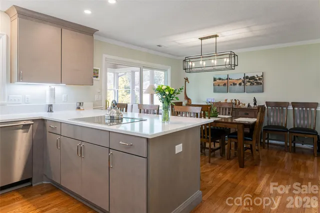 a kitchen with sink dining table and chairs