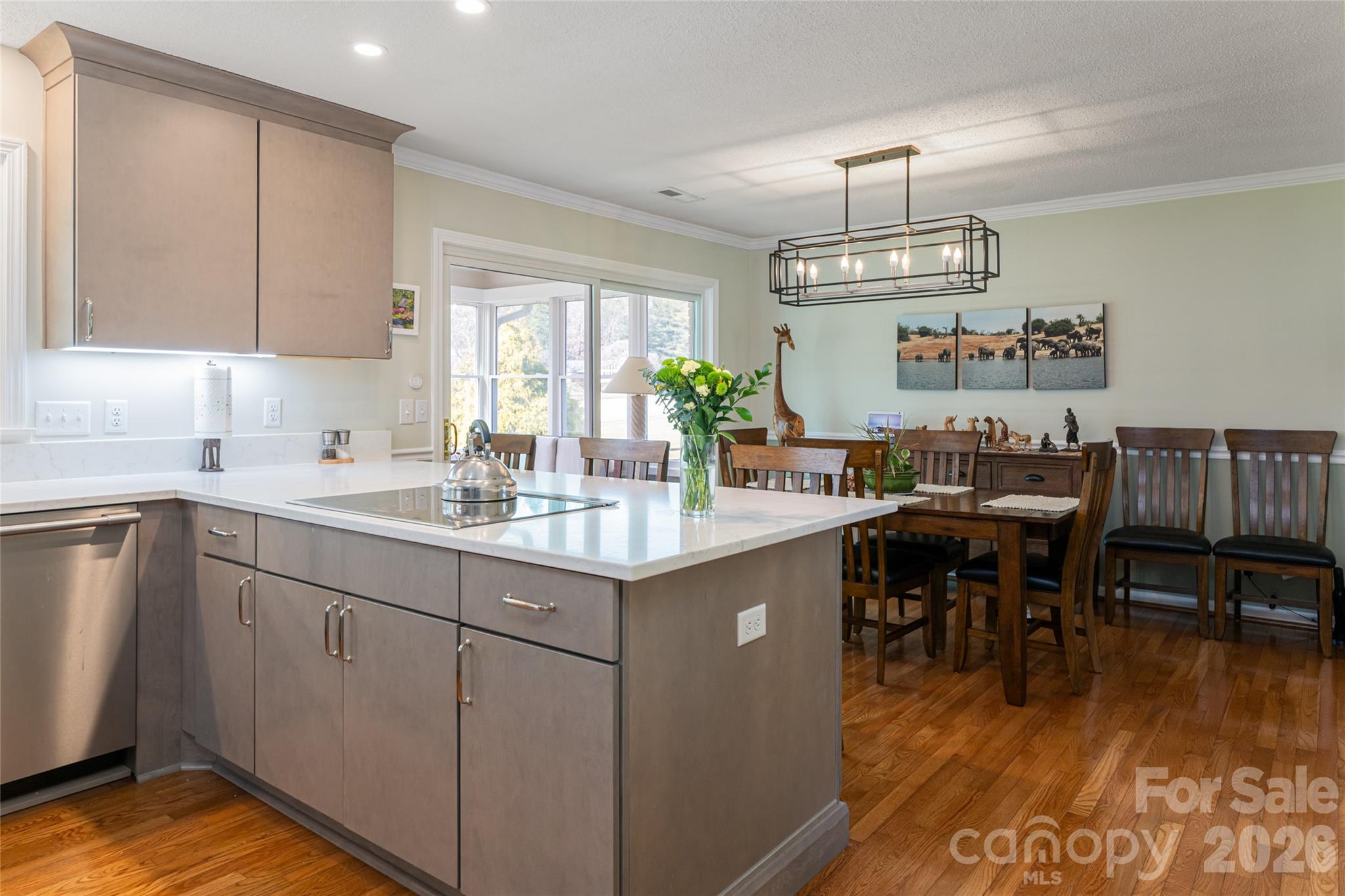 774 Crooked Creek Road Hendersonville, NC 28739 - Photo 13 of 46 a kitchen with sink dining table and chairs