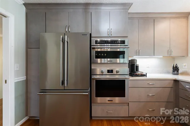 a kitchen with stainless steel appliances a refrigerator stove and sink
