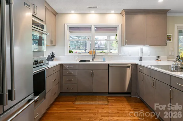 a kitchen with a sink cabinets and window