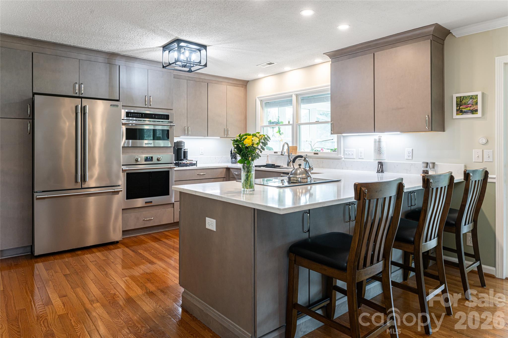 774 Crooked Creek Road Hendersonville, NC 28739 - Photo 16 of 46 a kitchen with stainless steel appliances a dining table chairs microwave and sink