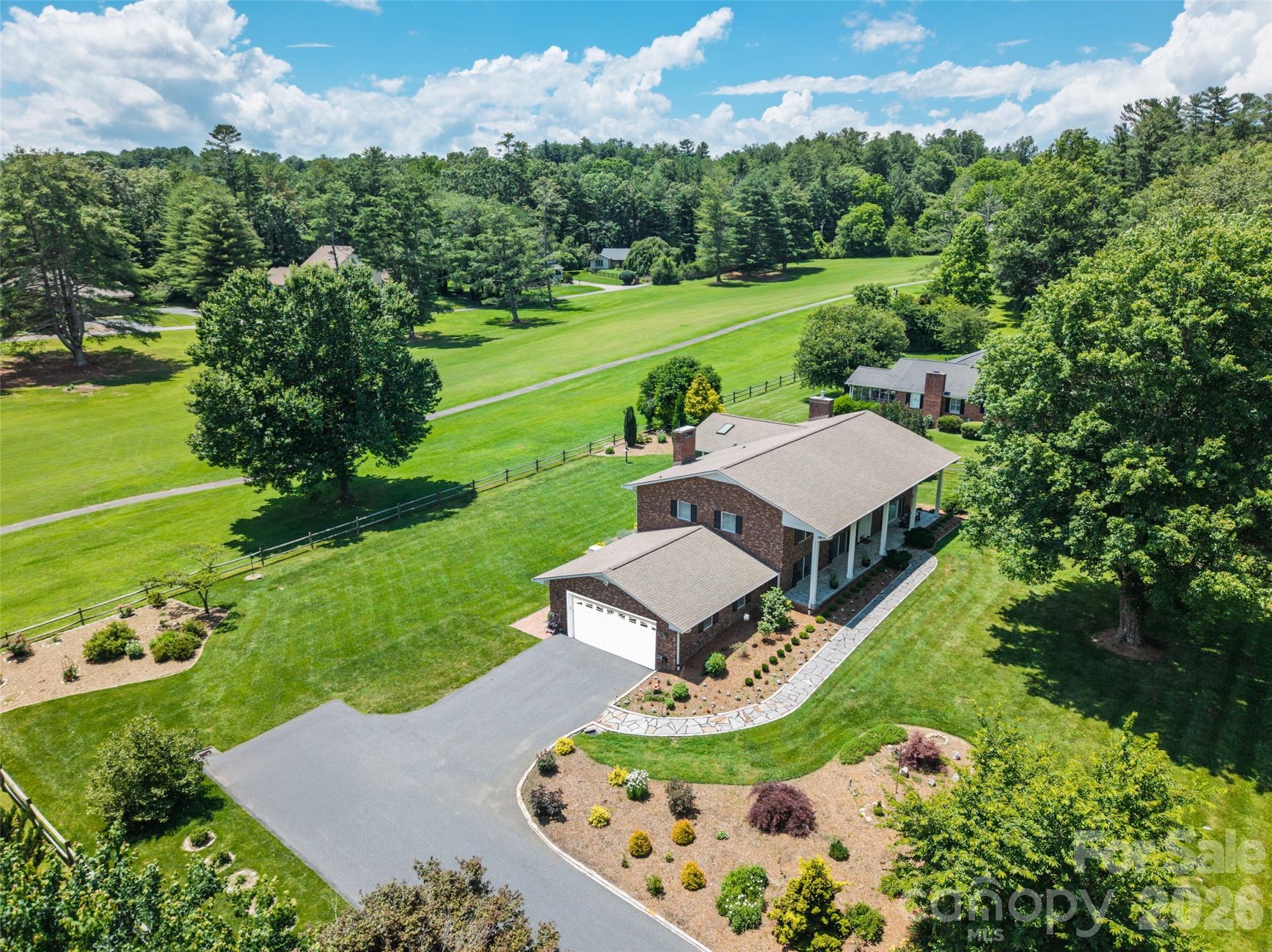 774 Crooked Creek Road Hendersonville, NC 28739 - Photo 2 of 46 an aerial view of a house with outdoor space pool seating area and yard