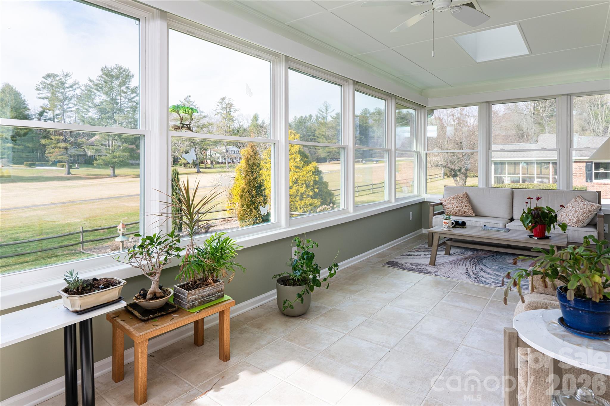 774 Crooked Creek Road Hendersonville, NC 28739 - Photo 27 of 46 a living room filled with furniture and a potted plant