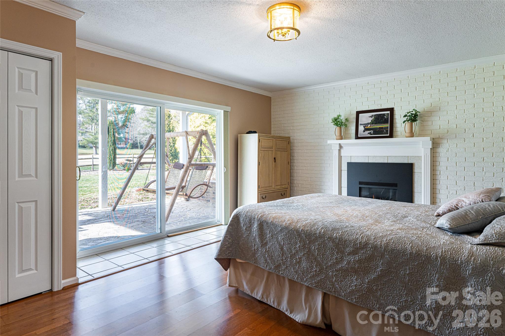 774 Crooked Creek Road Hendersonville, NC 28739 - Photo 34 of 46 a bedroom with a bed and a lamp